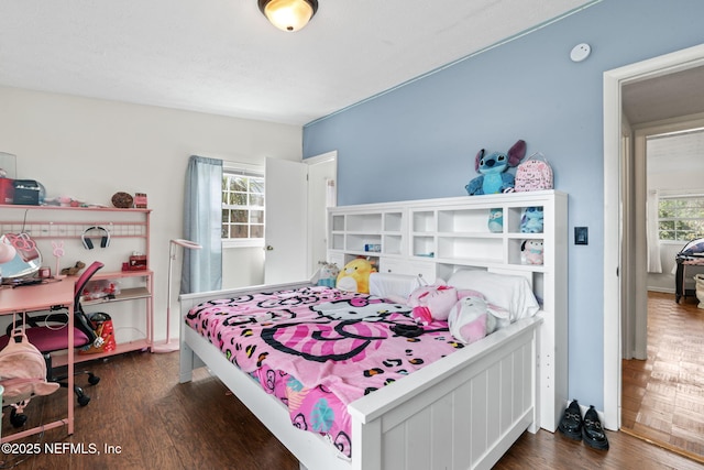 bedroom with dark hardwood / wood-style floors