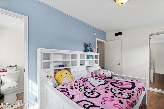 bedroom with dark hardwood / wood-style floors