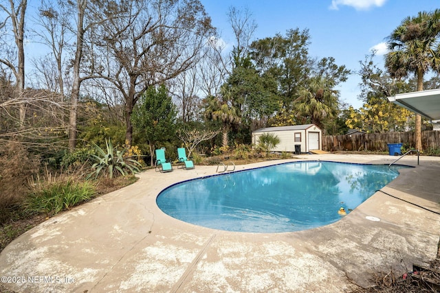 view of pool with a shed and a patio area