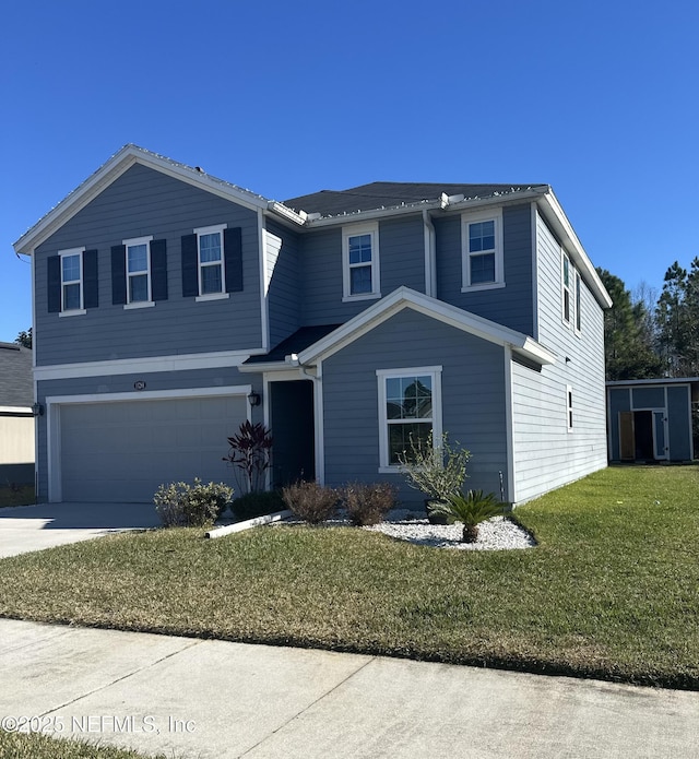 view of property with a garage and a front lawn