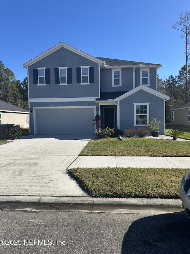 front of property with a garage and a front lawn