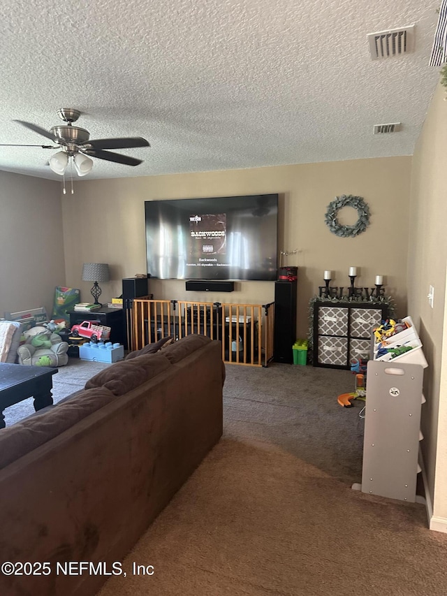 living room featuring carpet flooring, a textured ceiling, and ceiling fan