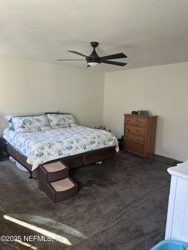 carpeted bedroom featuring a textured ceiling and ceiling fan