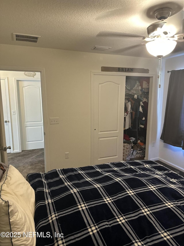 unfurnished bedroom featuring ceiling fan, a closet, carpet, and a textured ceiling