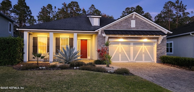 view of front of home with a yard and a garage