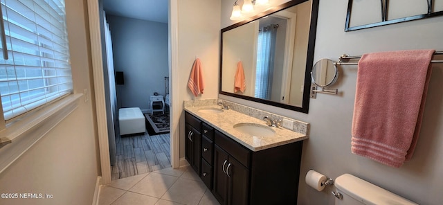 bathroom featuring tile patterned flooring, vanity, and toilet