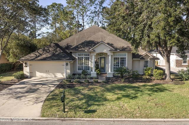 view of front of house with a front yard and a garage