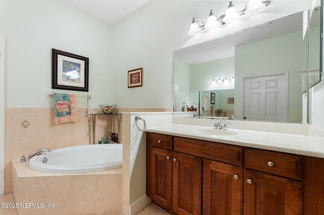 bathroom with a relaxing tiled tub, vanity, and tile patterned flooring