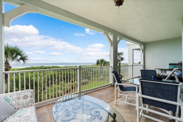 view of patio / terrace featuring a water view and a balcony