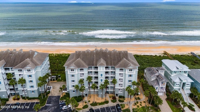 birds eye view of property with a water view and a view of the beach