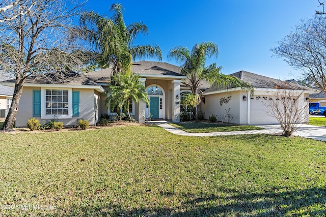 single story home featuring a garage and a front lawn