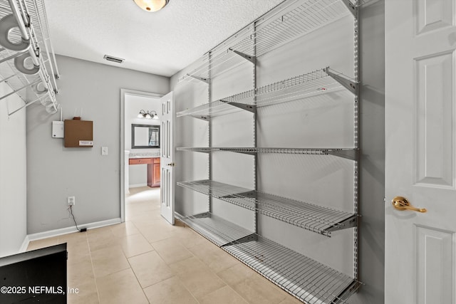 spacious closet with light tile patterned flooring