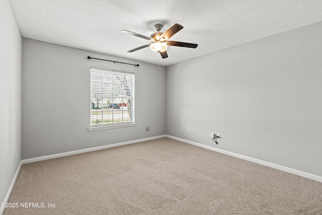 carpeted spare room with a textured ceiling and ceiling fan