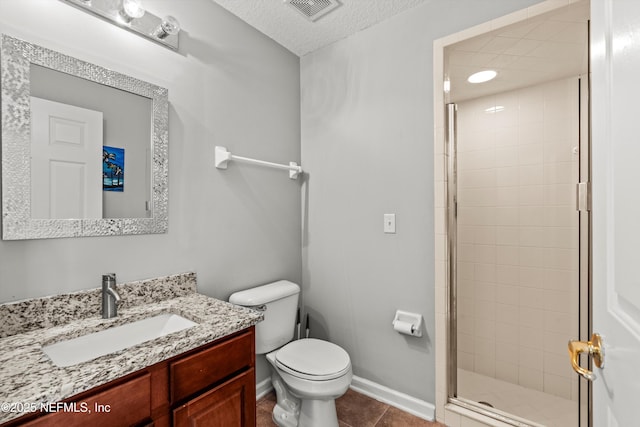 bathroom with tile patterned floors, an enclosed shower, a textured ceiling, toilet, and vanity