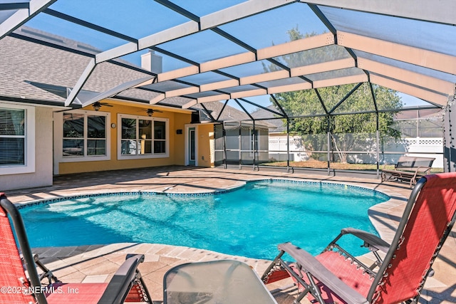 view of pool featuring a patio, ceiling fan, and a lanai