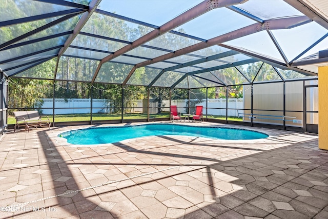 view of pool with a lanai and a patio area