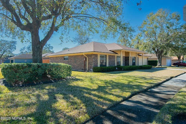 ranch-style home featuring a front yard