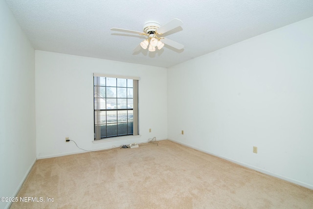 carpeted empty room featuring ceiling fan and a textured ceiling