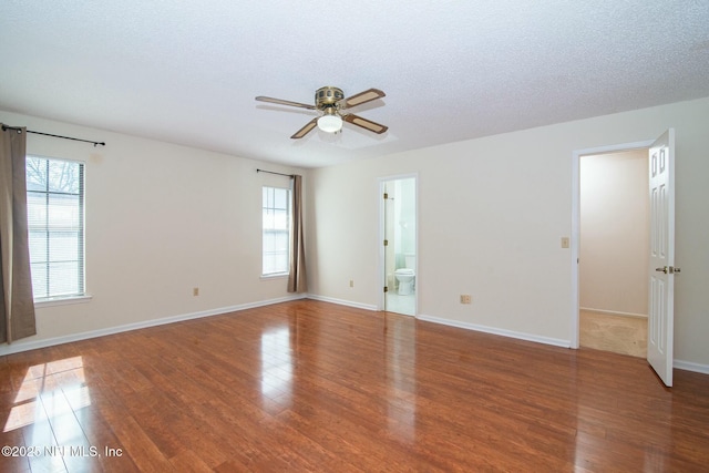 unfurnished room with a textured ceiling, ceiling fan, and hardwood / wood-style floors