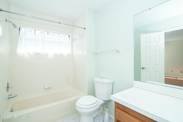 full bathroom with toilet, tile patterned flooring, tiled shower / bath combo, and vanity