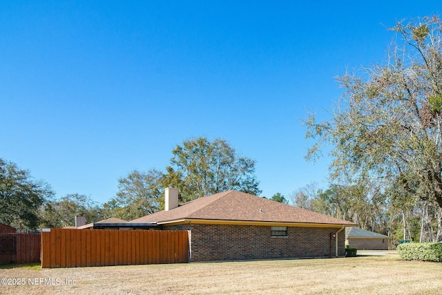 view of side of home featuring a yard