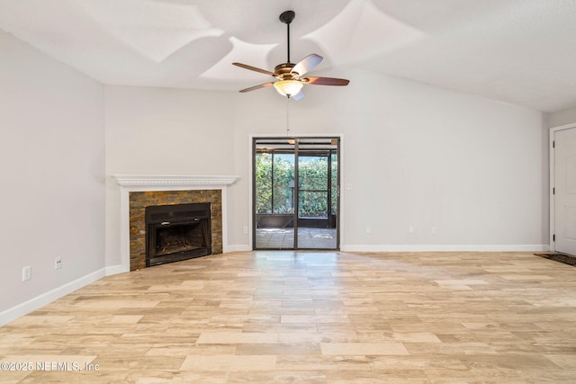 unfurnished living room featuring light hardwood / wood-style flooring, ceiling fan, lofted ceiling, and a tiled fireplace