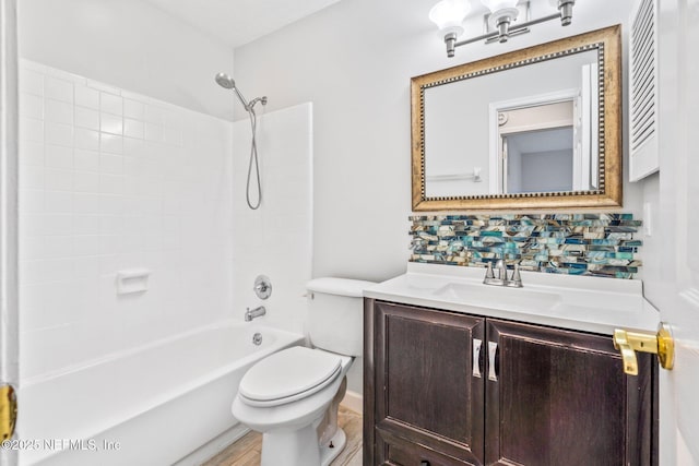 full bathroom featuring vanity, bathing tub / shower combination, toilet, and backsplash