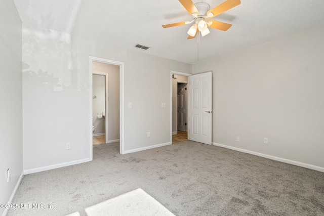 unfurnished bedroom with ceiling fan and light colored carpet