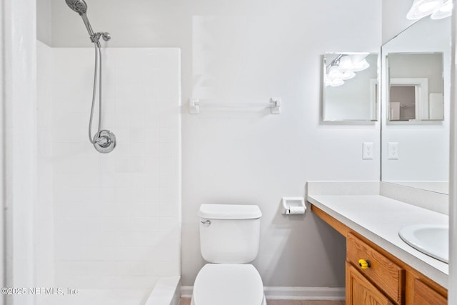 bathroom featuring a shower, vanity, and toilet