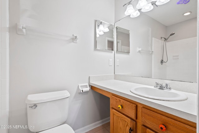 bathroom with tile patterned floors, vanity, toilet, and walk in shower