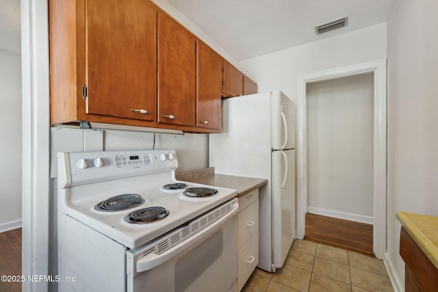 kitchen featuring electric stove and light tile patterned floors