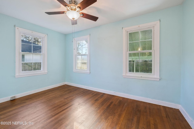 unfurnished room with ceiling fan and dark hardwood / wood-style flooring