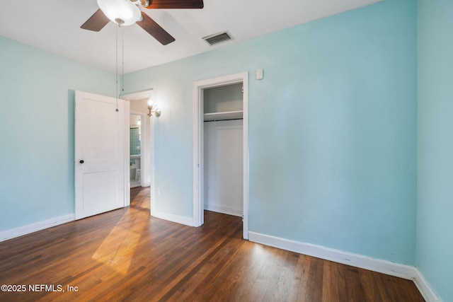 unfurnished bedroom featuring a closet, ceiling fan, and dark hardwood / wood-style flooring