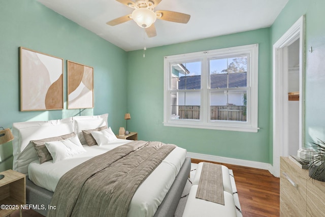 bedroom with dark wood-type flooring and ceiling fan