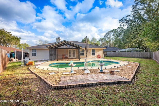 back of house featuring a fenced in pool, french doors, and a patio area