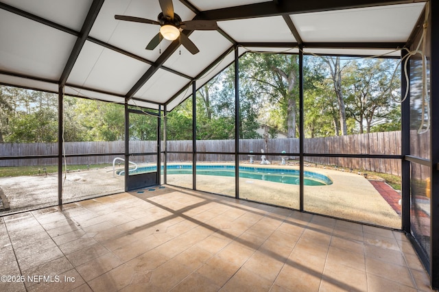 unfurnished sunroom featuring ceiling fan and vaulted ceiling