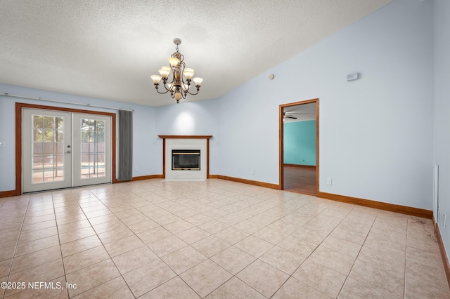 unfurnished living room with french doors, vaulted ceiling, a textured ceiling, light tile patterned floors, and ceiling fan with notable chandelier