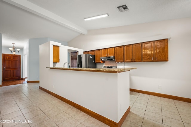 kitchen with light tile patterned flooring, vaulted ceiling with beams, a chandelier, stainless steel fridge, and kitchen peninsula