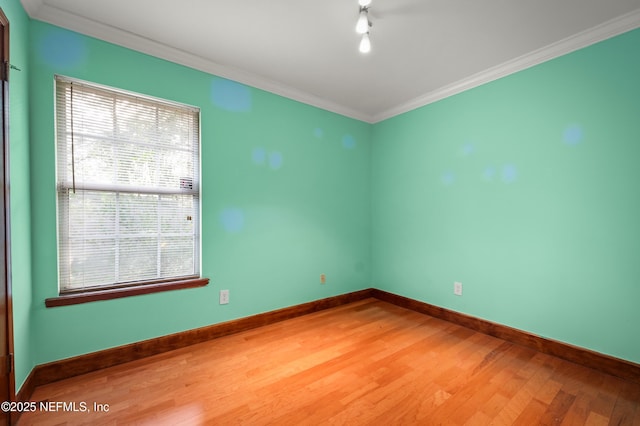 spare room featuring ornamental molding and wood-type flooring