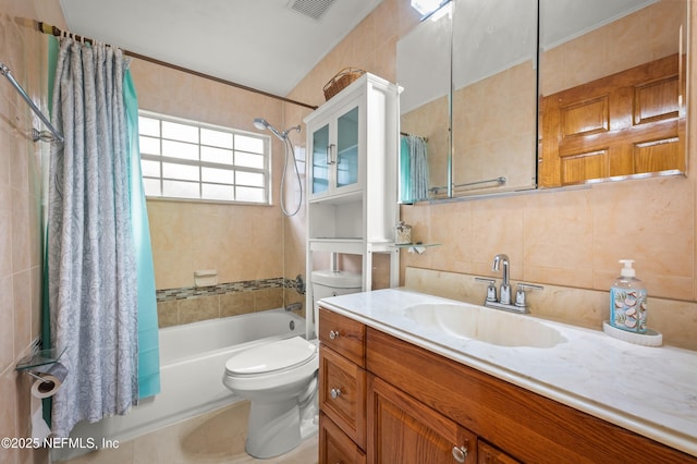 full bathroom featuring vanity, tile walls, shower / bath combination with curtain, and toilet