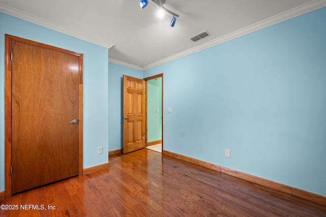 unfurnished bedroom featuring ornamental molding and light wood-type flooring