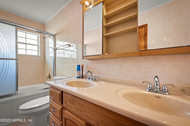 full bathroom featuring bath / shower combo with glass door, tile walls, decorative backsplash, vanity, and toilet