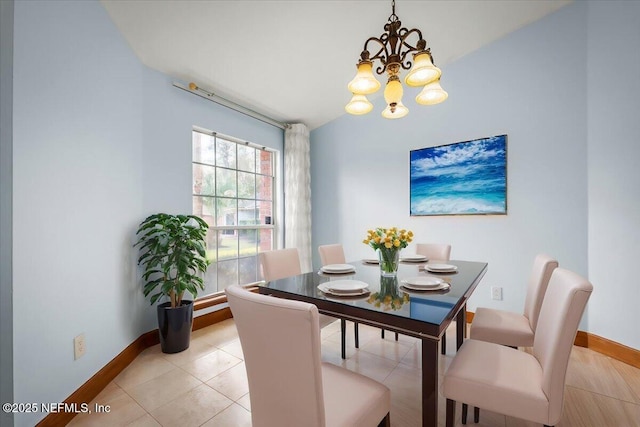 tiled dining space with a chandelier