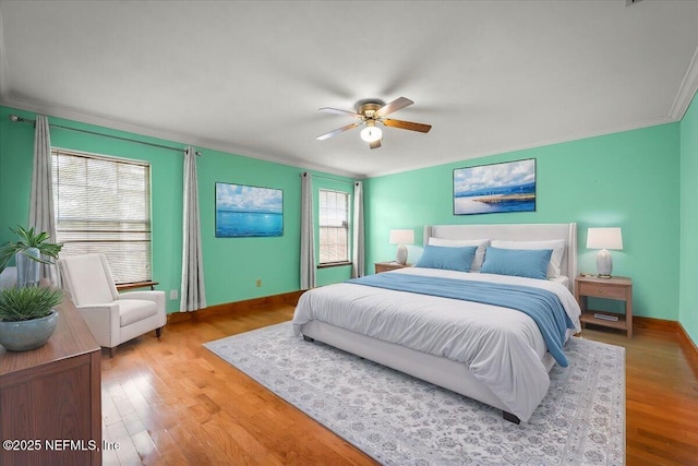 bedroom featuring crown molding, hardwood / wood-style flooring, and ceiling fan