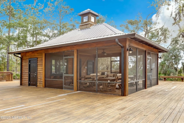 wooden deck with a sunroom