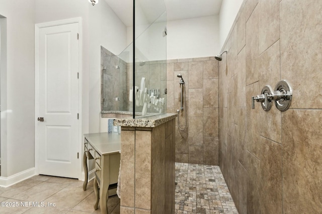 bathroom featuring tile patterned floors and tiled shower