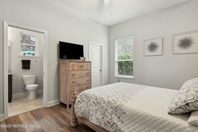 bedroom featuring ceiling fan, wood-type flooring, and connected bathroom