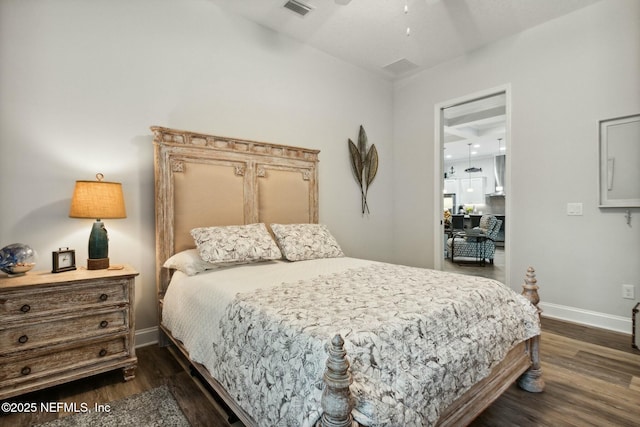 bedroom with ceiling fan and dark hardwood / wood-style floors