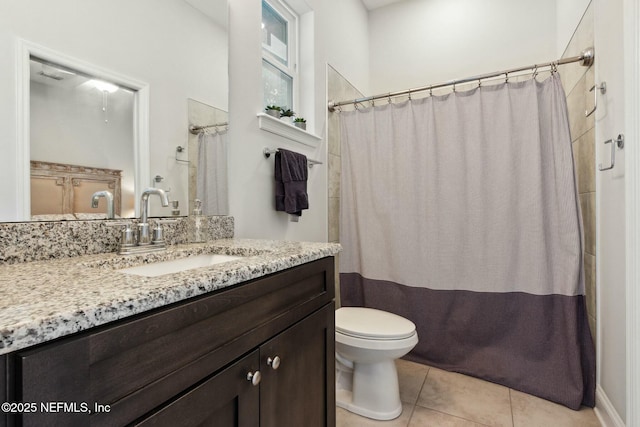 bathroom with tile patterned floors, a shower with curtain, vanity, and toilet