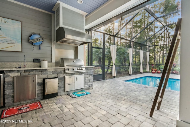 exterior space with an outdoor kitchen, sink, glass enclosure, a patio, and a grill